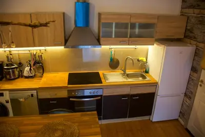 a small kitchen with a sink and a refrigerator at The Golden Hour Loft in Brussels