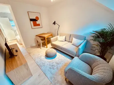 a living room with a couch and a chair at The Comfy for two - Brussels in Brussels