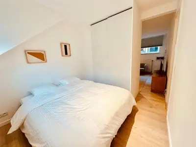 a bedroom with a bed in a white room at The Comfy for two - Brussels in Brussels