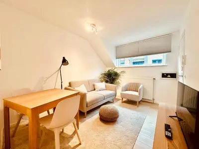 a living room with a couch and a table at The Comfy for two - Brussels in Brussels