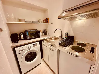 a kitchen with a washing machine and a washer at The Comfy for two - Brussels in Brussels