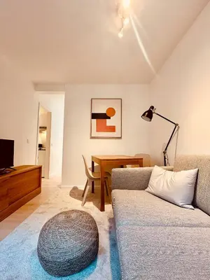 a living room with a couch and a table at The Comfy for two - Brussels in Brussels