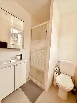 a white bathroom with a toilet and a sink at The Comfy for two - Brussels in Brussels
