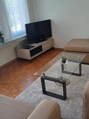 a living room with a television and a coffee table at Cosy -confort appartment in Antwerp