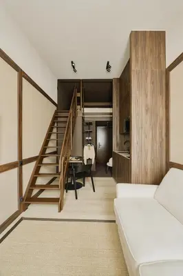 a living room with a staircase and a dining room at Raibu Ghent by StayC in Ghent