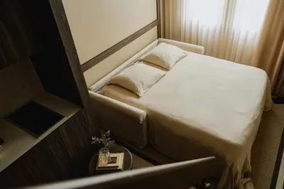 a hotel room with a bed and a table at Raibu Ghent by StayC in Ghent