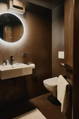 a bathroom with a sink and a toilet at Raibu Ghent by StayC in Ghent