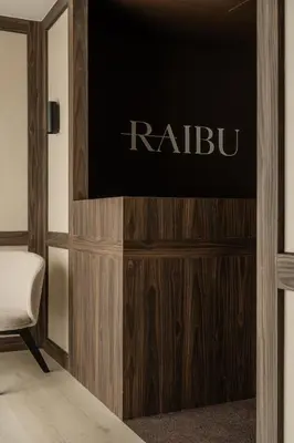 a flat screen tv sitting on top of a wooden entertainment center at Raibu Ghent by StayC in Ghent