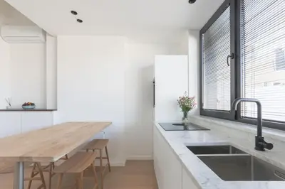 a kitchen with a wooden counter top and a sink at Southside Suites in Antwerp
