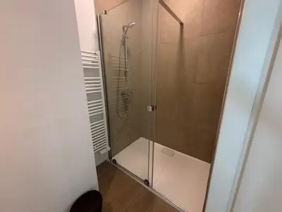 a shower with a glass door in a bathroom at Splendid Penthouse in City Center with Water View in Brussels