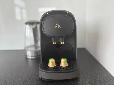 a coffee machine sitting on a counter with two cups at Splendid Penthouse in City Center with Water View in Brussels