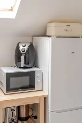 a kitchen with a microwave and a refrigerator at Elegant Stay in Châtelain Ixelles in Brussels