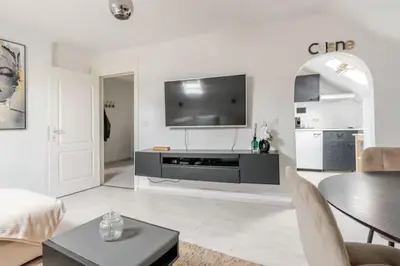 a living room with a flat screen tv on a wall at Elegant Stay in Châtelain Ixelles in Brussels