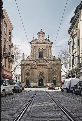 an old building with a clock tower on a street at Elegant Stay in Châtelain Ixelles in Brussels