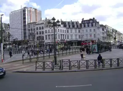 a city with buildings and people walking on a street at Elegant Stay in Châtelain Ixelles in Brussels