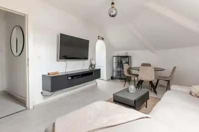 a white living room with a couch and a table at Elegant Stay in Châtelain Ixelles in Brussels