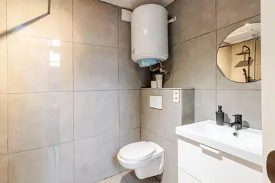 a bathroom with a toilet and a sink and a mirror at Elegant Stay in Châtelain Ixelles in Brussels