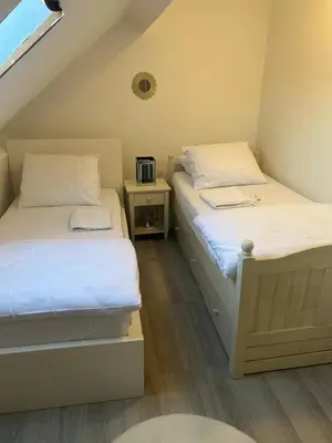 two twin beds in a small room with a window at Only For Tomorrowland in Boom