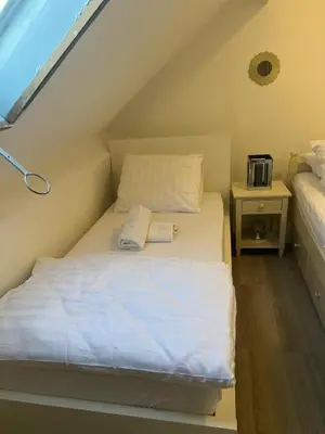 a small bedroom with a bed in the attic at Only For Tomorrowland in Boom
