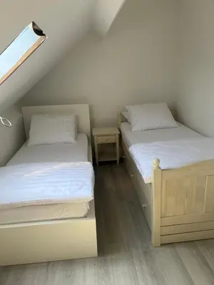 two twin beds in a room with a attic at Only For Tomorrowland in Boom