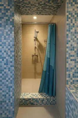 a bathroom with a shower with a blue shower curtain at Cosy studio Midi station in Brussels