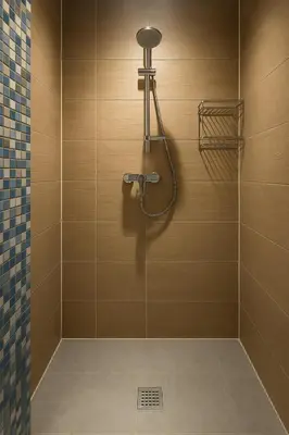 a bathroom with a shower with a shower head at Cosy studio Midi station in Brussels