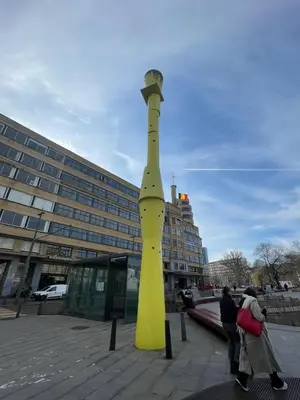 a large yellow object in front of a building at Le Flagey green place in Brussels