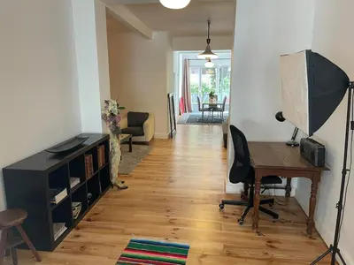 a living room with a desk and a table at Le Flagey green place in Brussels