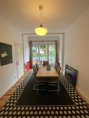 a dining room with a table and chairs at Le Flagey green place in Brussels