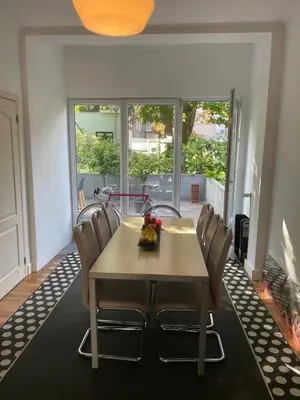 a dining room with a table and chairs at Le Flagey green place in Brussels