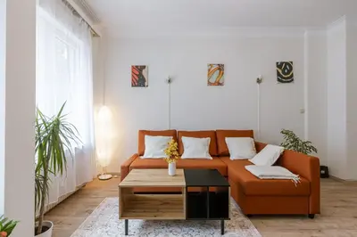 a living room with an orange couch and a coffee table at Bruxelles Cozy Atomium Expo in Brussels