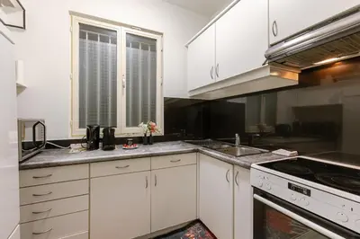 a kitchen with white cabinets and a sink at Bruxelles Cozy Atomium Expo in Brussels