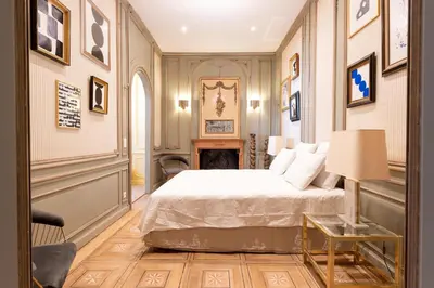 a bedroom with a bed and a fireplace at Les Appartements du Sablon in Brussels
