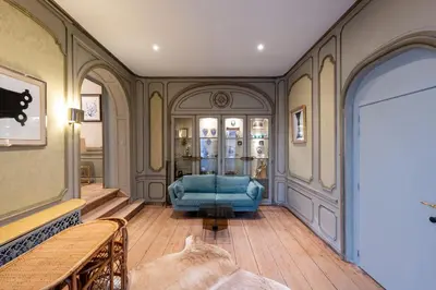 a living room with a blue couch in a room at Les Appartements du Sablon in Brussels