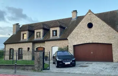 a car parked in front of a brick house at Luxe Villa Lou & Hans in Aalst