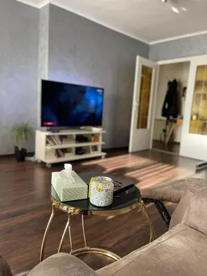 a living room with a tv and a coffee table at Cosy appartment near city center in Brussels