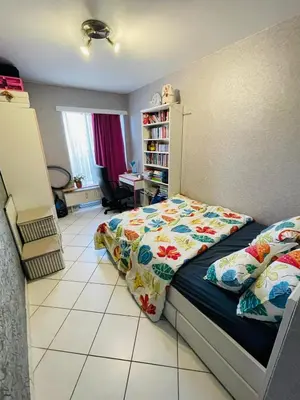 a bedroom with a bed and a book shelf at Cosy appartment near city center in Brussels