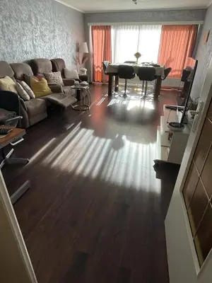 a living room with a couch and a table at Cosy appartment near city center in Brussels
