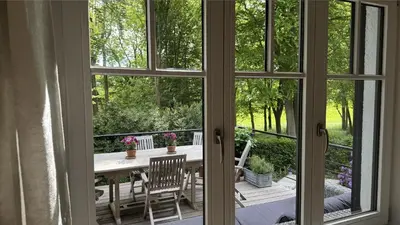 a view from a window of a patio with a table and chairs at PepperLake in Overijse