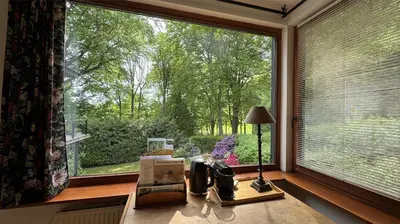 a window with a view of a garden outside at PepperLake in Overijse