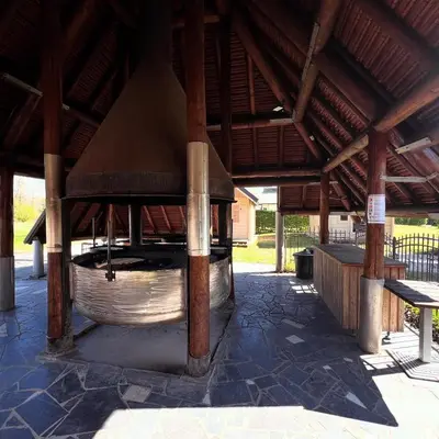 a large woodenilion with a large bell in the middle at Trekkershutten - Camping Groenpark in Zele
