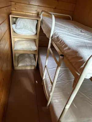a small room with two bunk beds in it at Trekkershutten - Camping Groenpark in Zele