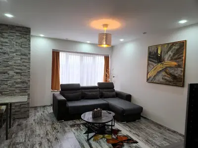 a living room with a couch and a table at New build flat - Walking distance from Brussels Airport in Zaventem