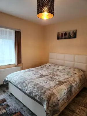 a bedroom with a large bed in a room at New build flat - Walking distance from Brussels Airport in Zaventem