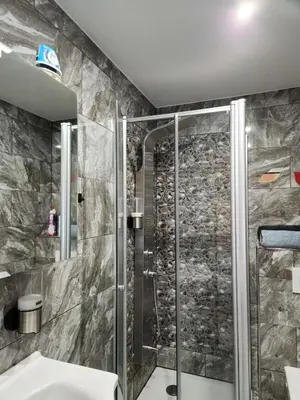 a bathroom with a shower and a sink at New build flat - Walking distance from Brussels Airport in Zaventem