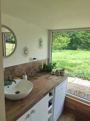 a bathroom with a sink and a large window at Naturedegrez in Grez-Doiceau