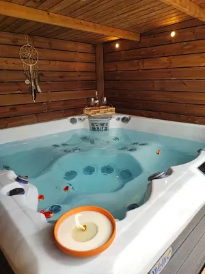 a jacuzzi tub with a candle in it at Naturedegrez in Grez-Doiceau