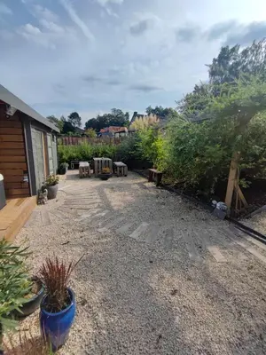a patio with tables and chairs in a yard at Naturedegrez in Grez-Doiceau
