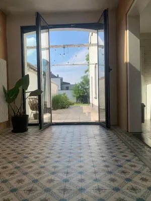 an open door to a hallway with a tile floor at Heritage Mansion near Tomorrowland in Niel