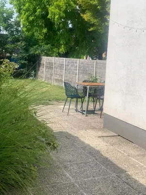 a patio with a table and chairs in a yard at Heritage Mansion near Tomorrowland in Niel